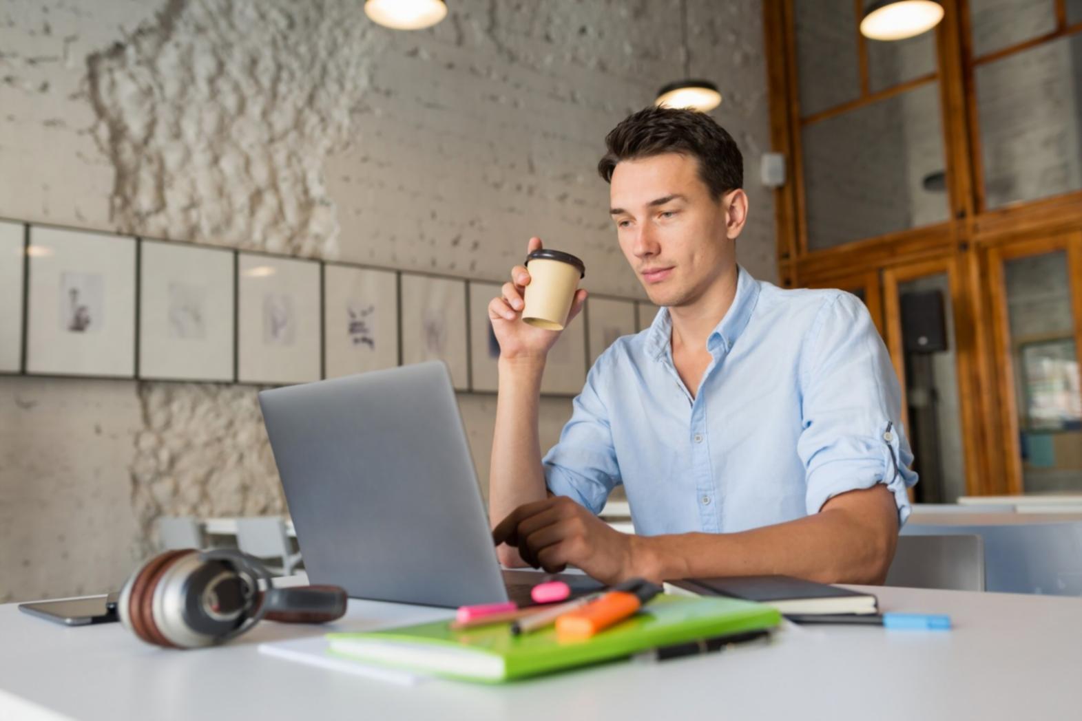 Financial analyst reviewing market research at desk with multiple monitors